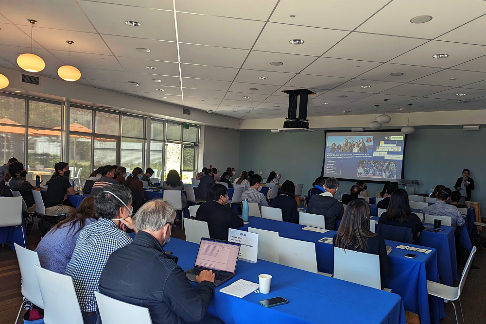 Dr. Anna Molofsky delivering her keynote in front of attendees in the Terrace Room at the Neurobehavioral Genetics Retreat hosted on May 12, 2022 at the Annenberg Community Beach House. Attendees are wearing masks in compliance with the event's COVID-19 guidelines.